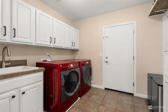 This utility room is exceptionally spacious with a convenient sink. Ample storage ensures everything has its place. W & D included.