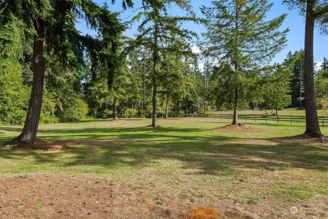 This 10-acre property boasts a park-like setting offering complete privacy.