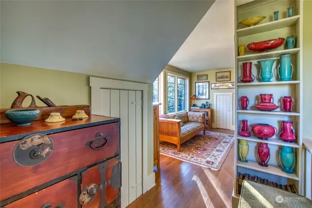 Upstairs is another bedroom, with storage closets tucked under the eaves.