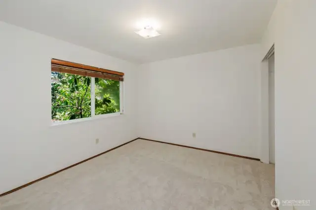 Bedroom 1 overlooking back yard and huge rhododendron