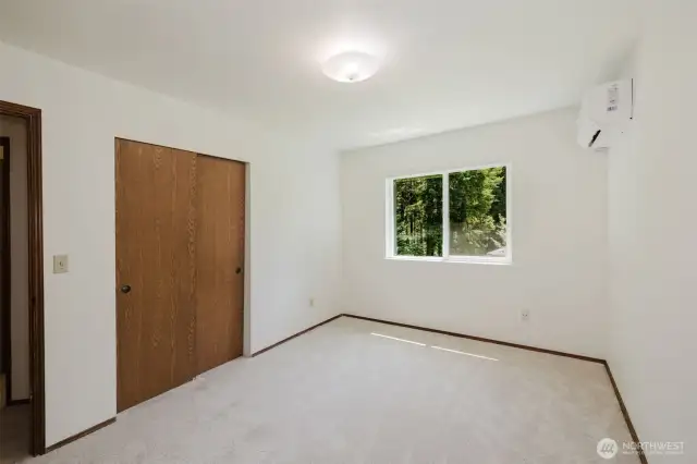 Bedroom 2 overlooking spacious side yard and gardens. Southern exposure offers exceptional natural light.