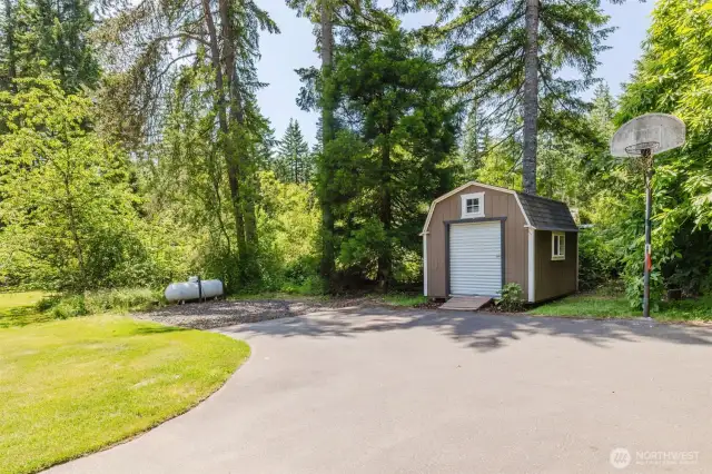 Driveway with space for RV/boat parking and a storage shed for yard tools