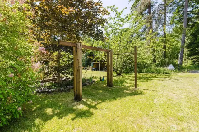 Play set next to "secret garden" that leads to another outbuilding that has been used as a play house