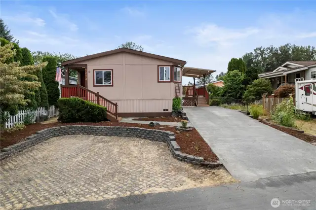 Front view of newer home for sale in 55 older Ranier Manor nicely landscaped,Rv Parking,trext decking and 2 covered decks ready for newer owners