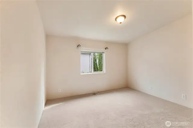 View of good sized second bedroom with new carpets and high ceilings also