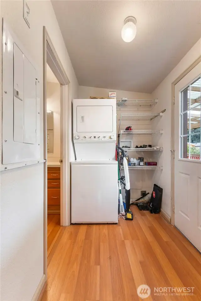 Here is back door view of utility room with washer and dryer with built in shelving