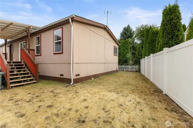 Back yard view of this partially fenced flat yard with room for animals and or garden area