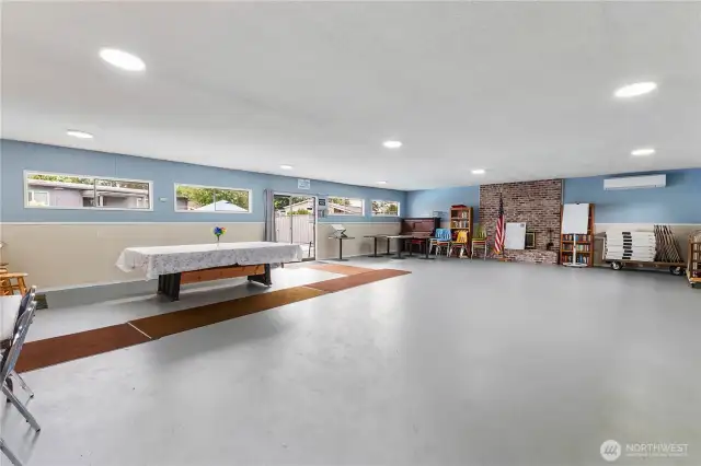 Inside view of clubhouse game room leading to in ground pool area.  Lots of room for all your guest with AC kitchen also