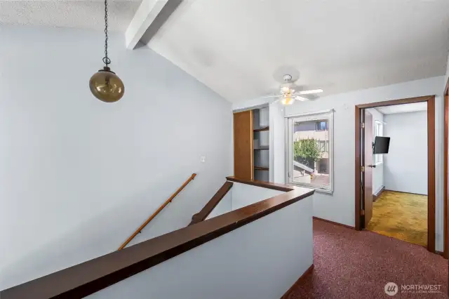 You're upstairs. Storage, natural light and lofty ceiling make it feel really spacious.