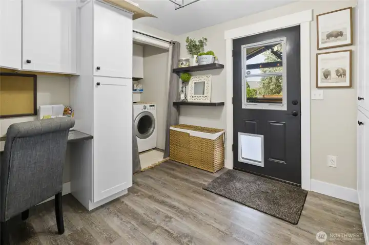 Custom office area and lots of storage and door leads to back yard oasis.