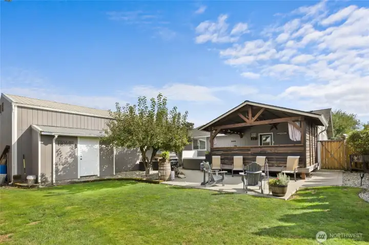 Backyard and Detached shop has attached storage shed perfect for all your yard tools.