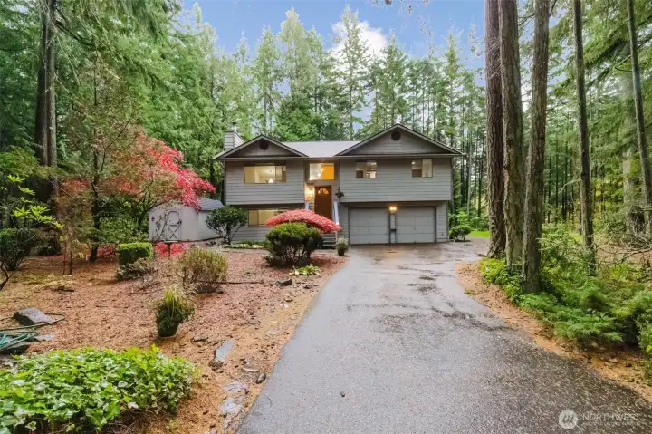 Beautifully landscaped front yard with a welcoming driveway and charming curb appeal