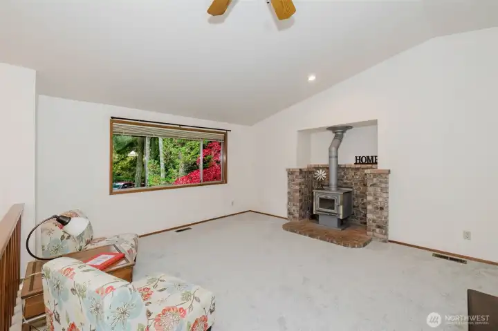 Cozy living room featuring a classic fireplace and abundant natural light