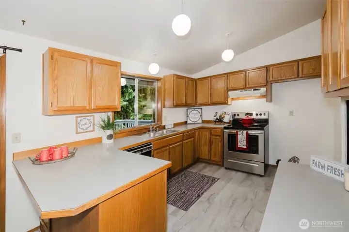 Abundant cabinets and counter tops will make all your Holiday entertaining a pleasure! Notice the new laminate flooring! So easy to care for! You'll be happy to clean up with the view of the tranquil forest that surrounds the home.