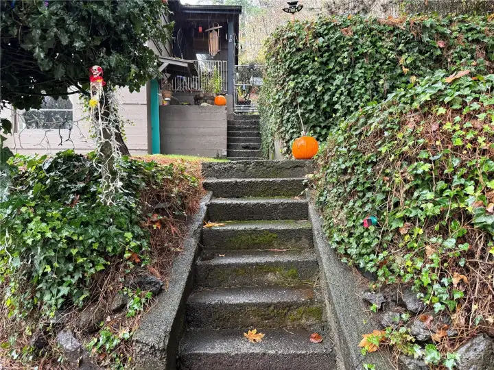 Up the stairs to the lower unit and then a fenced area with stairs to the upper unit.