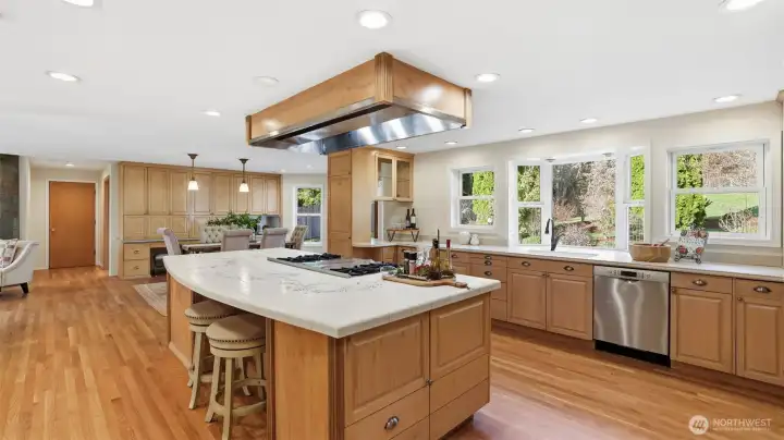 Huge kitchen island surrounded by custom cabinetry.