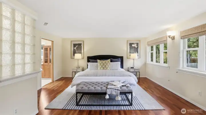 Brazilian cherry hardwood floors. Primary bath highlighted by glass block to the left.