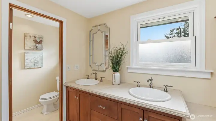 Heated tile floors for comfort. Travertine shower to the left.