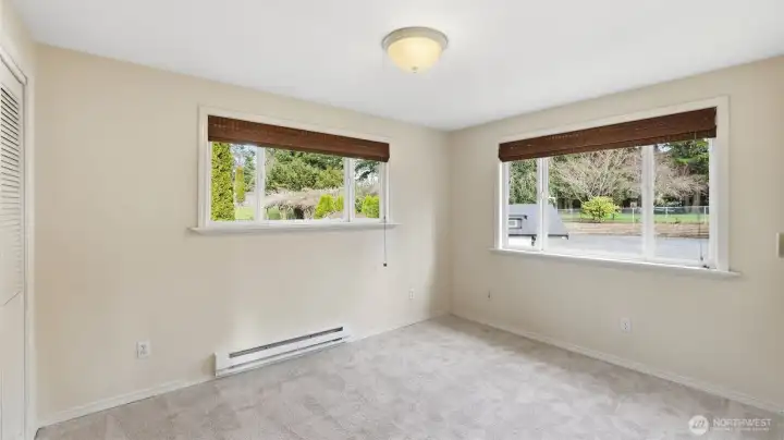 One of two secondary upstairs bedrooms featuring new carpet and abundant light.