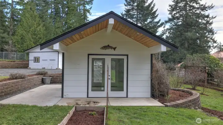 The "She Shed" feature vaulted ceiling and covered patio, waiting to become your private reading nook, favorite craft area, yoga salon, or art studio.