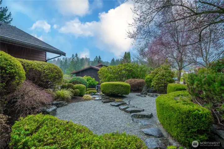 Natual stone paths leading to the driveway and garage.