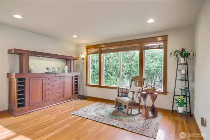 A versatile room off of the kitchen can be used as a main level tv room or formal seating and dining.