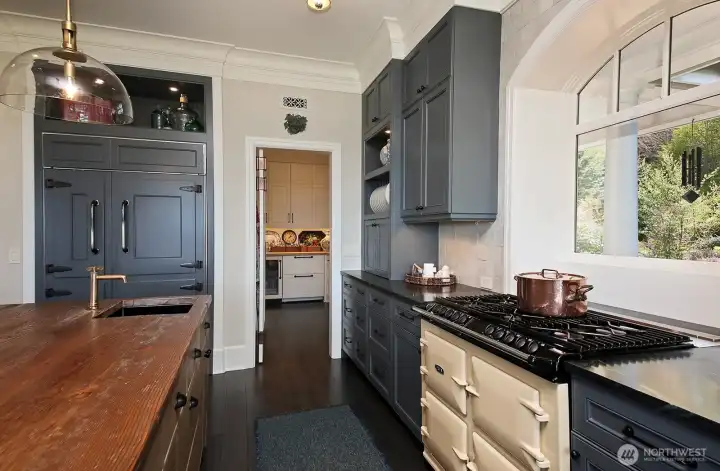 Look at the fantastic Aga oven and paneled refrigerator! The door leads to the butler's pantry.