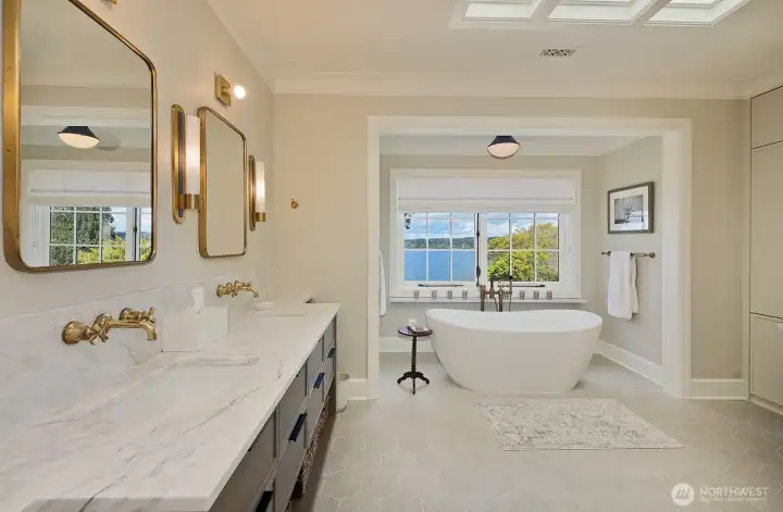 Primary bath with luxurious soaking tub, skylights, and stunning view.