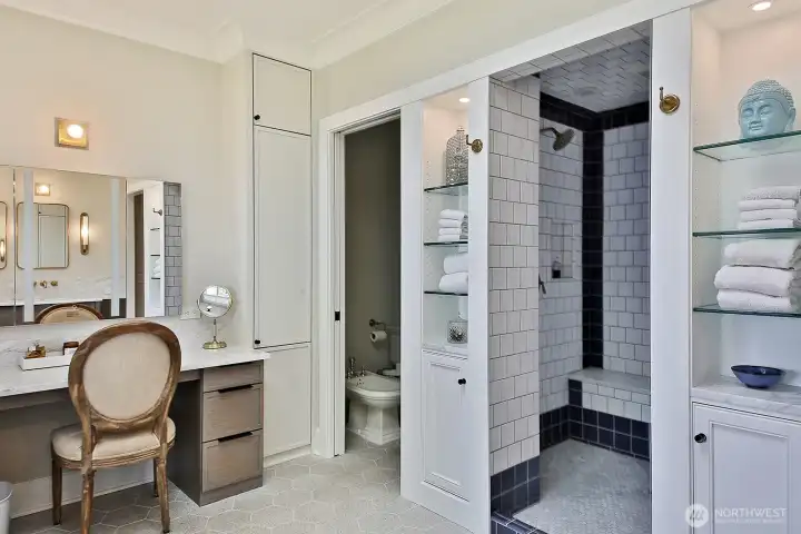 Walk-in shower and dressing table in the primary bath.