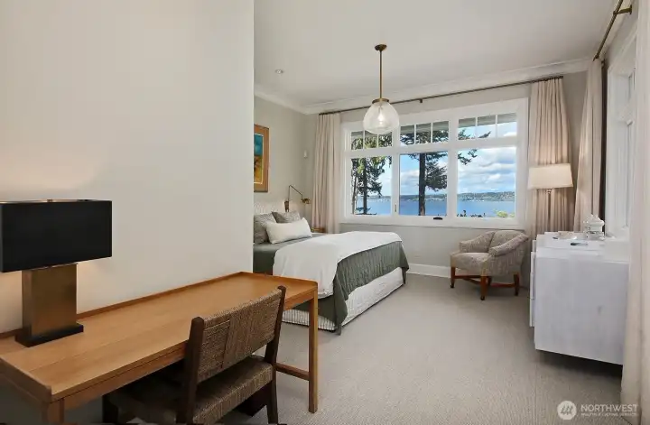 Spacious guest bedroom shares the views.