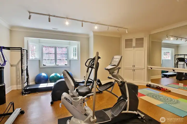 An exercise studio with plenty of room for all of your equipment - note the mirror and barre.