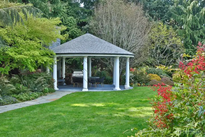 Dine al fresco in the gazebo with fireplace, tucked into a corner of the garden.