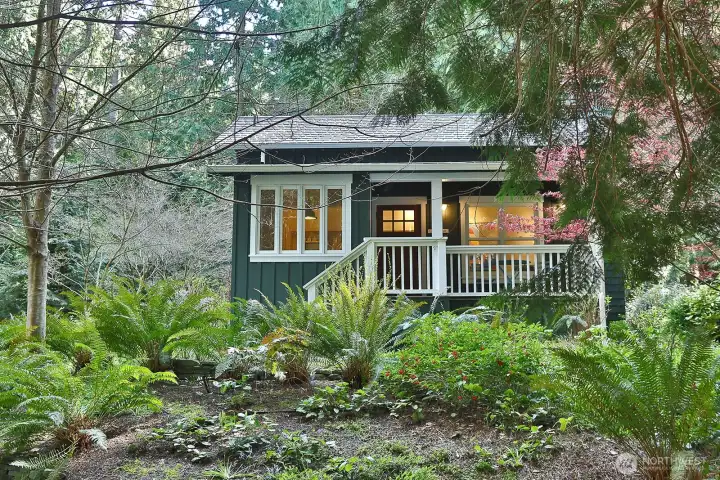 Designed by Ross Chapin, the guest cottage includes one bedroom, a full bath with soaking tub, and two covered porches.