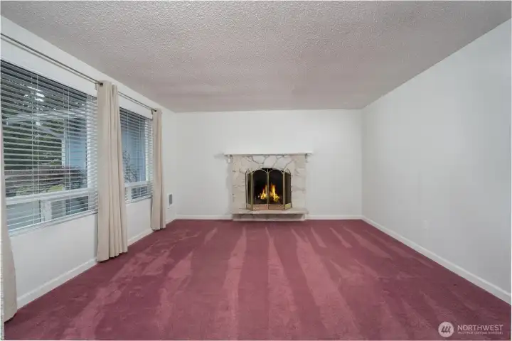 As you step through the front door, you're welcomed into the formal living room with a beautiful wood-burning fireplace.
