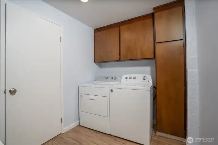 Laundry area offers ample storage space to keep things organized.