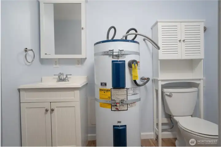 A bathroom is conveniently located just off the mudroom, which has a separate entrance from the main door.