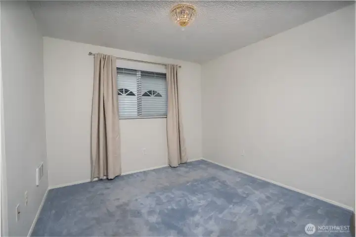 A second bedroom is conveniently located near the primary suite.