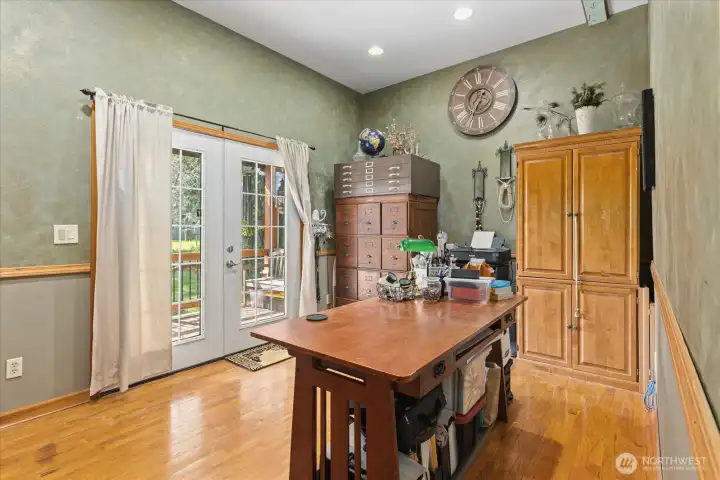 Main level office space with french doors leading out to the front deck.