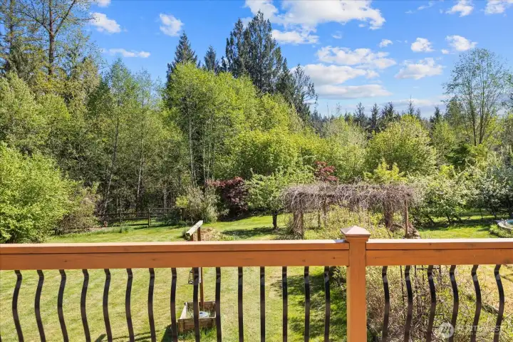 Main level - deck overlooking the extensive landscaping including ornamental and native trees. Fruit and nut trees (apple, pear, plum, fig, hazelnut, cherry, mulberry). Berry bushes and vines (blueberry, blackberry, raspberry, kiwi, chokecherry)