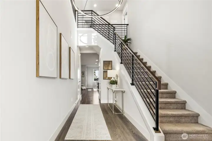 Soaring ceilings, elegant hardwood floors, sleek metal railing and designer light fixtures add style and sophistication.