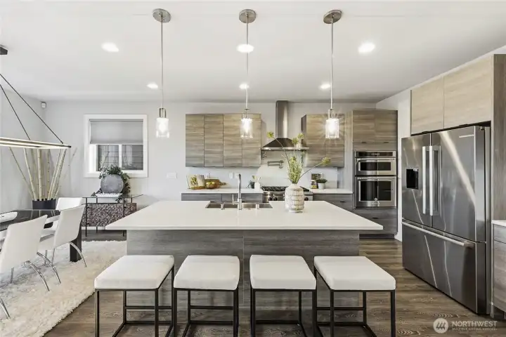 Gourmet kitchen boasts quartz countertops, sophisticated soft-close cabinetry, gas cooktop with pot-filler, KitchenAid and Bosch appliances, stainless steel farmhouse sink, full-height tile backsplash, and a generous island designed for gathering and entertaining.