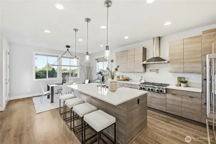 Gourmet kitchen boasts quartz countertops, sophisticated soft-close cabinetry, gas cooktop with pot-filler, KitchenAid and Bosch appliances, stainless steel farmhouse sink, full-height tile backsplash, and a generous island designed for gathering and entertaining.