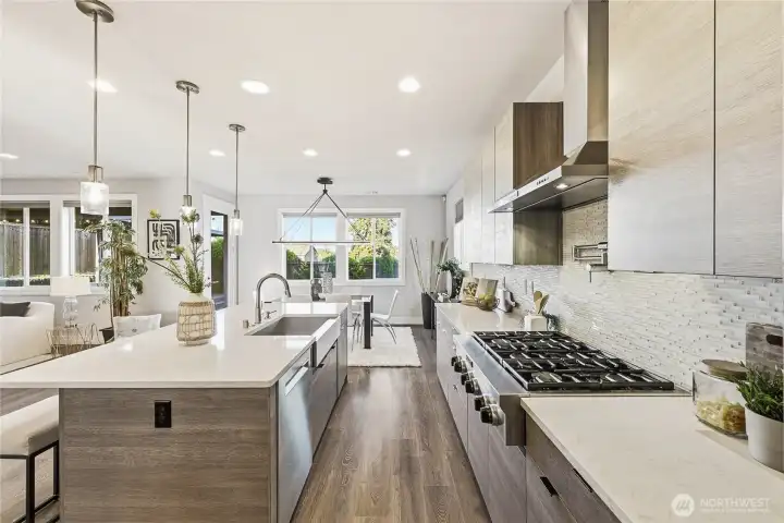 Another view of the gourmet kitchen showcasing its seamless connection to the dining area and open-concept design.