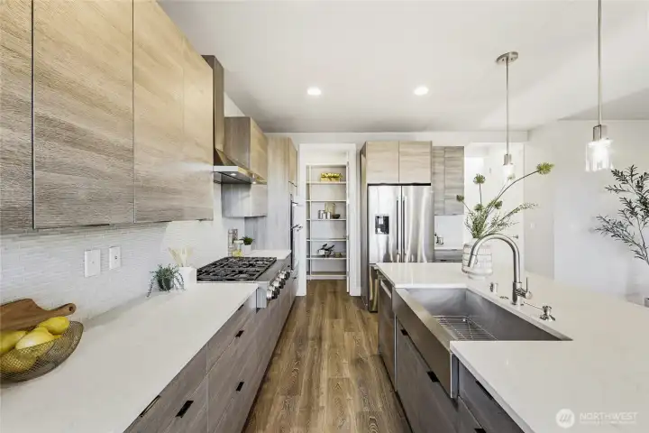From the dining area, a view into the beautifully organized walk-in pantry with custom built-ins by Closets by Design.
