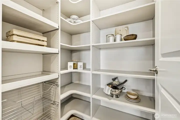 Custom walk-in pantry by Closets by Design keeps everything beautifully organized while maximizing storage and functionality.
