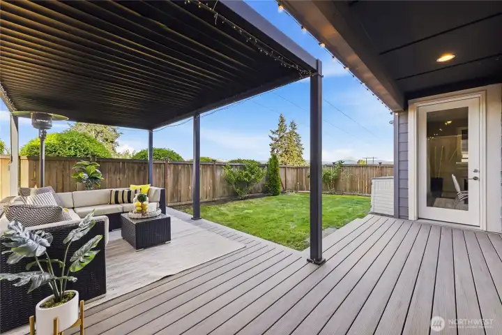 The covered louvered pergola and composite deck create a peaceful outdoor retreat with backyard privacy and Mt. Rainier views in the distance.