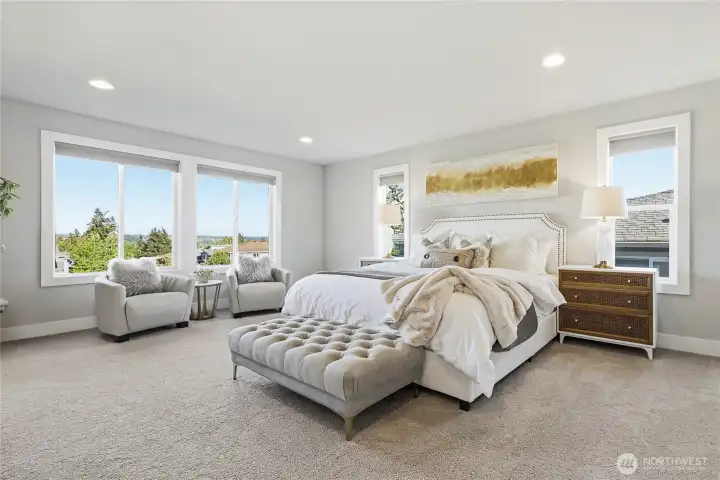 The spacious, Pinterest-worthy primary suite was designed as a true retreat, offering peaceful backyard and open-space views with partial views of Mount Rainier beyond