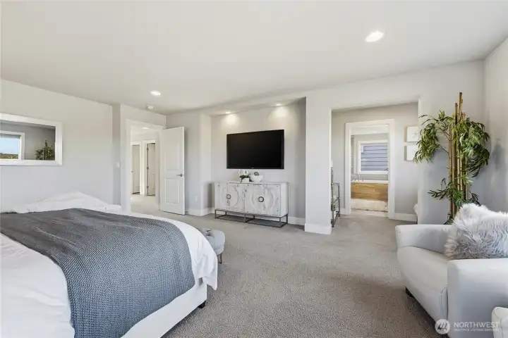 Another view of the primary suite with the boutique-style alcove in view that creates a peaceful transition to the spa-inspired bath.