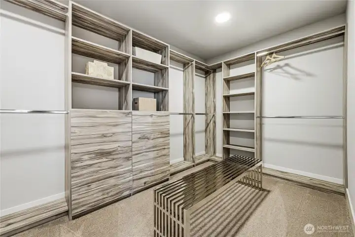 The oversized primary closet is enhanced with a custom-built organization system by Closets by Design, offering effortless structure and elevated storage.