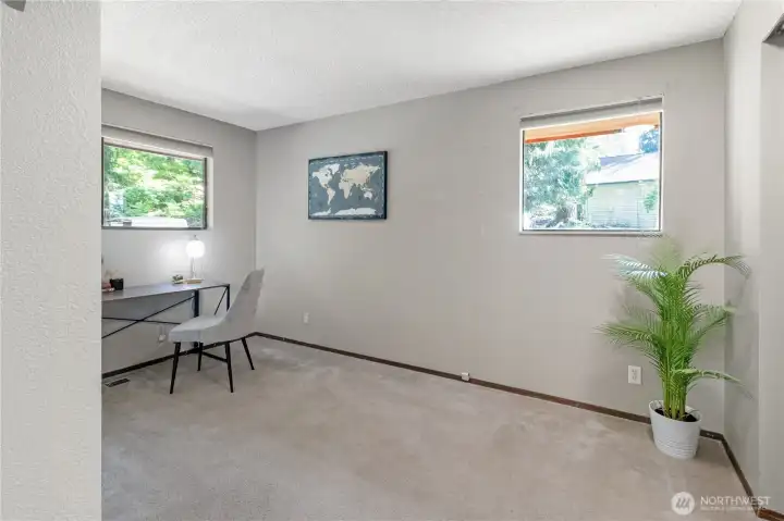 Bright secondary bedroom with large windows